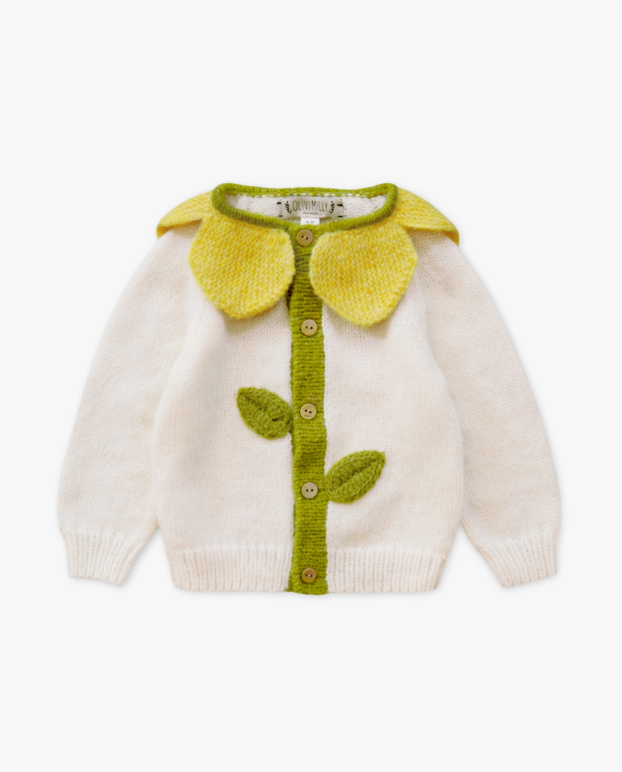 Children's sweater with green floral design on a white background